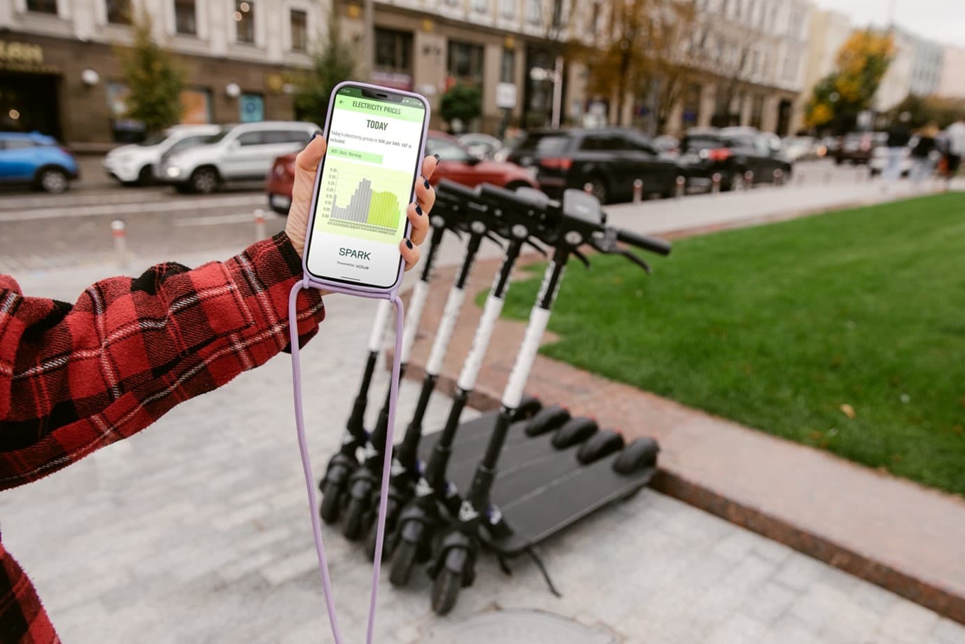 Phone app with escooters in city landscape